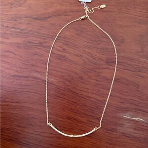 Lauren Ralph Lauren gold-tone pavé crystal curved bar frontal necklace.